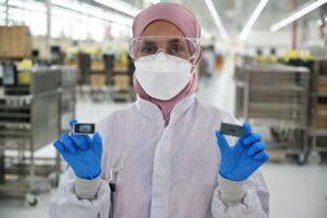 A factory technician at Intel’s Penang Assembly Test facility displays Intel Core Ultra processors before they are shipped from the factory